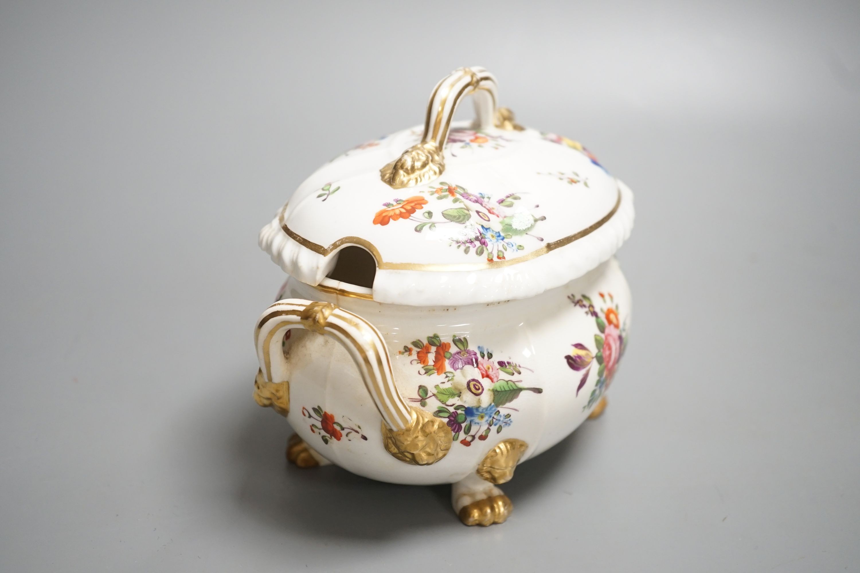 A Derby tureen and cover, early 19th century, on four feet with lion head masks painted with flowers, red mark, overall height 13.5cm